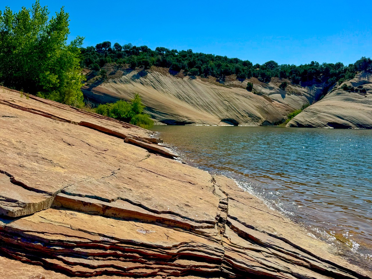 Red rock formations and a lake