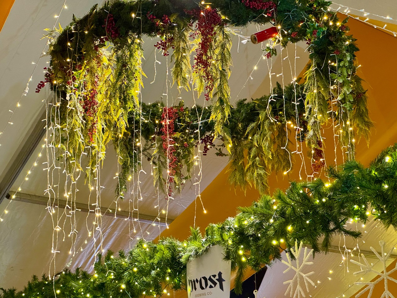 Evergreen garlands hung with holiday lights